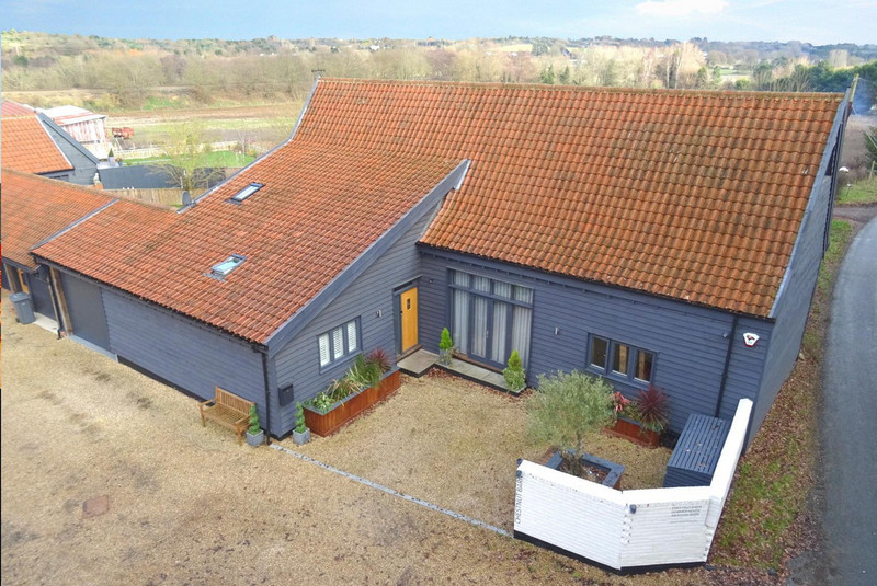 A superb, substantial barn conversion offering spacious and flexible living space, with exposed timbers, four bedrooms; two with en-suites and a further shower room, bespoke kitchen and a generous garden with pleasant outlook. This is contemporary...
