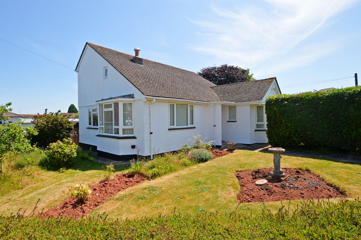 A DETACHED CHALET BUNGALOW OCCUPYING A LARGE LEVEL CORNER PLOT